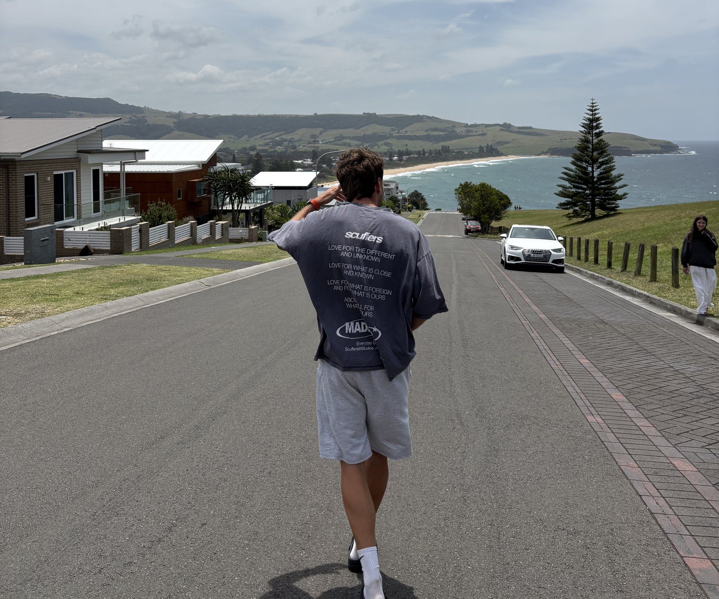 Pablo walks down a street towards the Australian coast