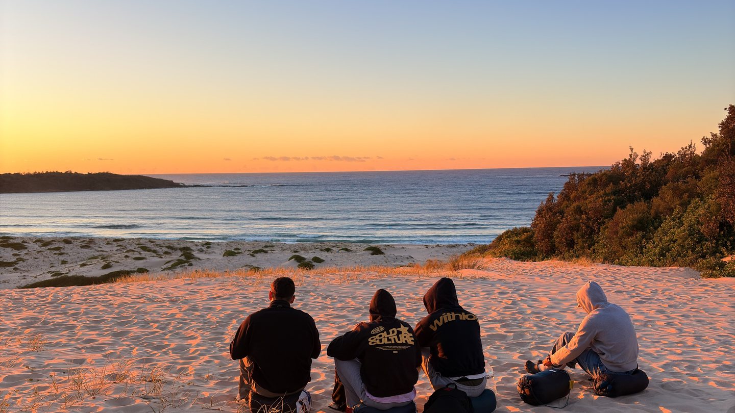 Warm light over dunes, friends and the sea